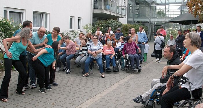 Menschen schauen einer Tanzgruppe zu